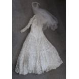 A vintage lace wedding dress and veil headpiece Condition report: Available upon request