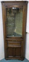 A 20th century oak glazed corner cabinet 174cm high and a gilt framed wall mirror (2) Condition