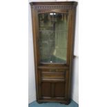 A 20th century oak glazed corner cabinet 174cm high and a gilt framed wall mirror (2) Condition