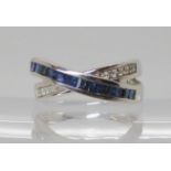 A 14k gold sapphire and diamond cross over ring, finger size O, weight 5.8gms Condition report: