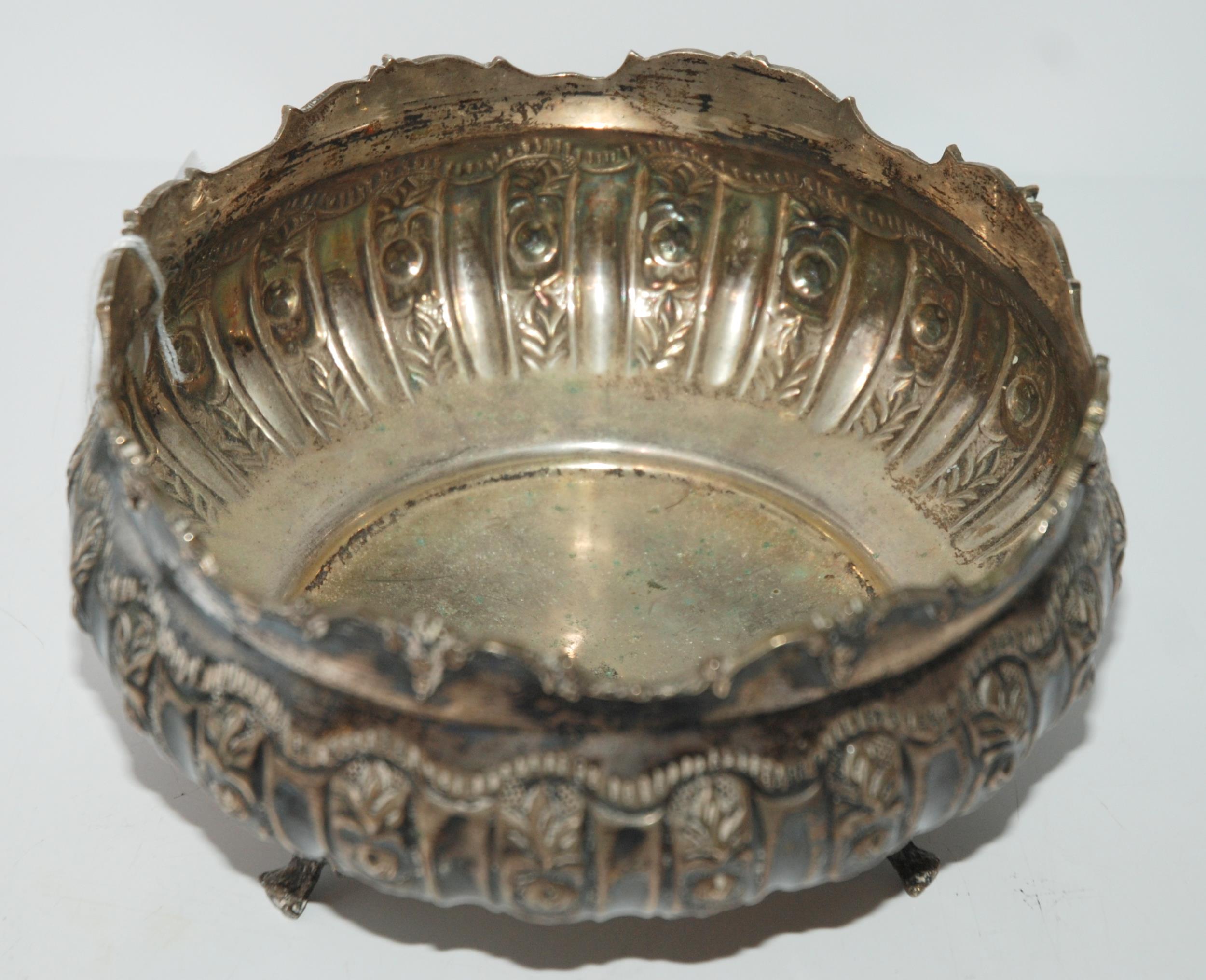 An 800 silver bowl, circular with foliate embossed decoration on three outswept feet 16 cm dia. - Image 2 of 2
