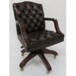 A 20th century button back revolving desk chair 92cm high Condition report: Available upon request