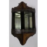 An Edwardian mahogany and satinwood inlay mirrored corner shelf with to fretwork galleried