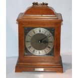 A early 20th Century mantel clock fitted for electricity with presentation plaque, 35cm high