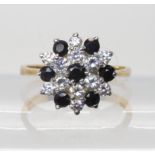 A 9ct gold sapphire and cz flower cluster ring, size O1/2, diameter 1.4cm, weight 3gms Light general