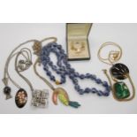 A string of blue and white oriental beads with a Toucan pendant and other items A condition report