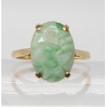 A 9ct gold Chinese green hardstone ring, carved with flowers. Dimensions of the stone 16.1mm x 11.