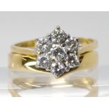 An 18ct gold diamond flower ring, set with estimated approx 0.75cts of brilliant cut diamonds,