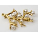 A bright yellow metal pearl set branch brooch, indistinctly stamped 750, weight 6.6gms This brooch