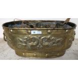A Victorian oblong brass planter embossed with fish and fleur de lys with two lion mask ring