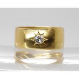 An 18ct gold gents band ring with star set diamond of estimated approx 0.20cts, finger size T1/2,