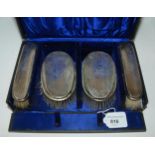 A cased set of four silver-backed hair brushes, Birmingham 1915 Condition report: Available upon