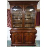 A Victorian mahogany glazed bookcase with two glazed doors above single lined drawer above two