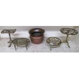 A lot comprising four assorted brass trivets and a copper urn (5) Condition report: Available upon