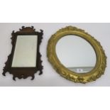 A 19th century mahogany framed bevelled glass wall mirror and a gilt framed Rococo style oval wall