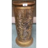 A early 20th century brass umbrella stand embossed with stylized tavern scene and three assorted