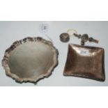 A lot comprising a silver card tray, rubbed marks, 15.5cm, a baby rattle, pill box and a hammered