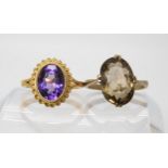 A 9ct gold amethyst set ring size L1/2, together with a smoky quartz set ring with decorative 9ct