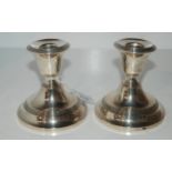 A pair of silver dwarf candlesticks, Birmingham 1919, 11cm high Condition report: Available upon