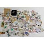 A lot comprising a cased silver five pound coin and a small quantity of stamps Condition report: