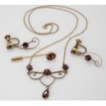 A 9ct gold garnet set pendant necklace with matching screw back earrings and a lapel pin, weight