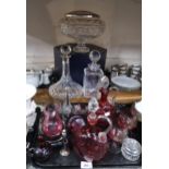 A quantity of cut glass and crystal including a pair of cranberry glass pitchers, a Caithness