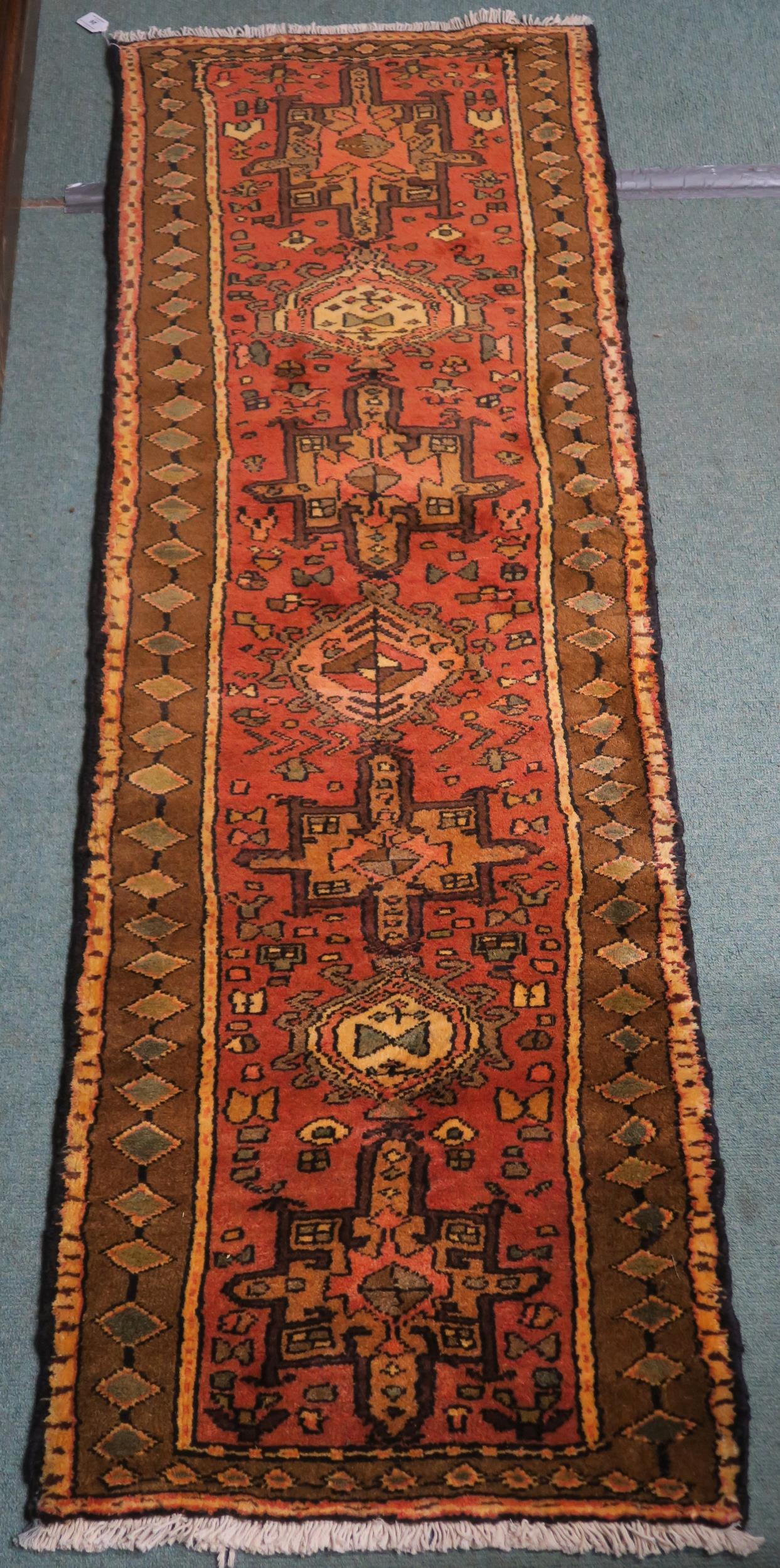 A terracotta ground Karajeh runner, 200cm long x 70cm wide Condition report: Available upon request