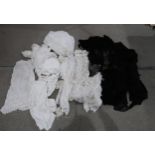 A lot comprising a large selection of black lace fabric, black lace shawls, an embroidered lace