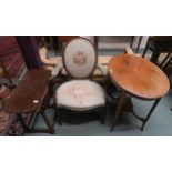 A Victorian mahogany oval occasional table, early 20th century upholstered parlour armchair and an
