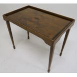 A 20th century mahogany and walnut veneered folding tray and a carved oak tea tray (2) Condition