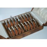 A cased set of four silver toast racks, Sheffield 1935, four section, 7.5cm wide, 208 grams