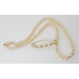 A string of pearls with a 9ct gold box clasp, length of pearls 42cm, together with a gold plated