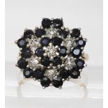 A 9ct sapphire and diamond accent flower cluster ring, size Q1/2, diameter approx 2cm, weight 4.8gms