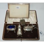 A lot comprising a cased three-piece condiment set, Birmingham 1929, a rectangular silver-mounted