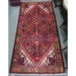 A red ground Hamadan rug with allover design, 194cm x 102cm Condition report: Available upon