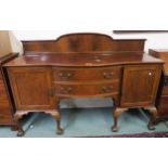 A 20th century mahogany Queen Anne style sideboard with two central drawers flanked by cabinet doors
