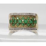 A 9ct wide band ring set with diamonds and emeralds, finger size R1/2, weight 4.2gms Light general