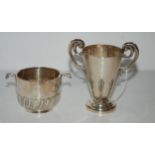 A lot comprising a silver double-handled cup, Birmingham 1904, 12cm high and a silver porringer,