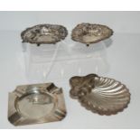 A lot comprising a pair of silver bob bon dishes, a silver shell-shaped butter dish and a silver