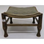 An early 20th century elm footstool with shaped seat and carved supports, 25cm high x 38cm wide x