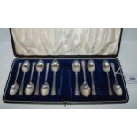 A cased part set (ten) silver coffee spoons, missing two plus tongs and an odd silver coffee