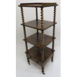 A Victorian mahogany four tier what-not with single drawer, barley twist upright on turned