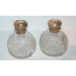 A pair of silver-topped cut glass scent bottles, rubbed marks Condition Report:Available upon