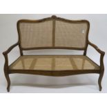 An early 20th century mahogany framed bergere settee, 99cm high x 129cm wide x 55cm deep Condition