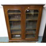 A 20th century stained oak glazed two door bookcase, 147cm high x 127cm wide x 32cm deep Condition