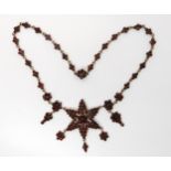 A gilded white metal red gem set star necklace Condition Report:Condition report not available for