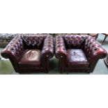 A pair of contemporary oxblood leather upholstered chesterfield club chairs, 70cm high x 102cm