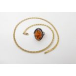 A 9ct gold ribbon chain, length 41cm, weight 5.7gms, together with a Polish silver amber ring size