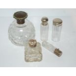 A faux tortoiseshell topped scent bottle, two silver-topped scent bottles and two white-metal topped