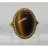 A 9ct gold ring set with tiger's eye, size S1/2, weight 7.5gms Condition Report:Available upon